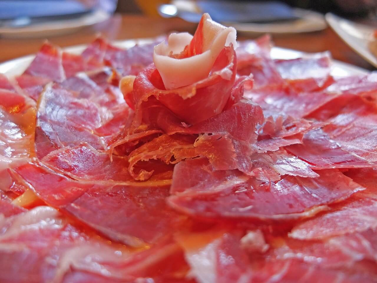 Fresh cut Iberian ham displayed in a rosette