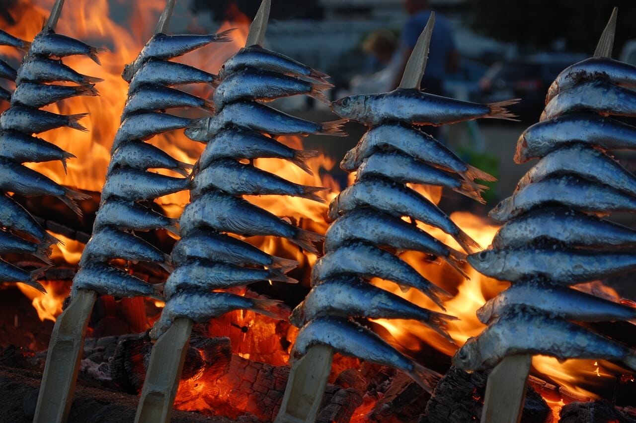 Sardines cooking over an olive wood fire in Costa de Sol, southern Spain, Estepona.