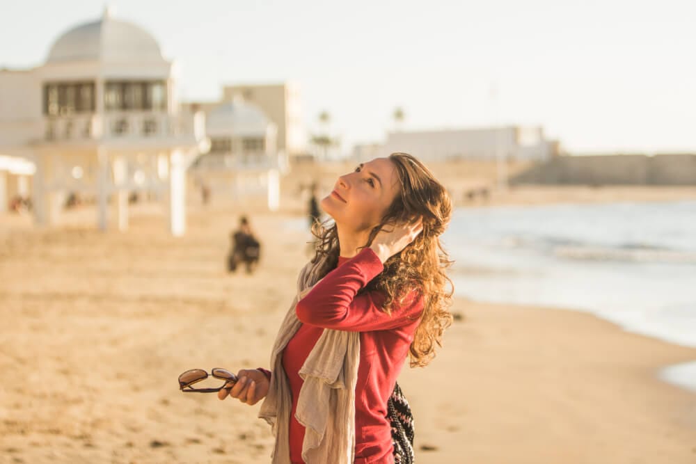 A woman taking time away from her tour with Inbound Spain to enjoy the beach in Cadiz.