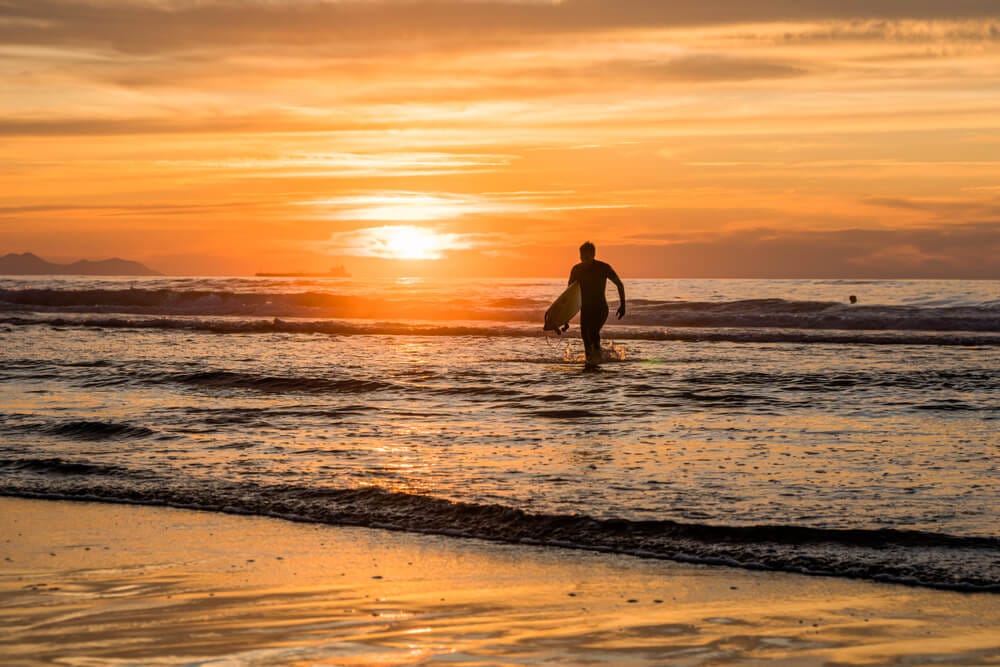 Surfer catching a wave at Zurriola Beach in San Sebastian, a popular local surf spot